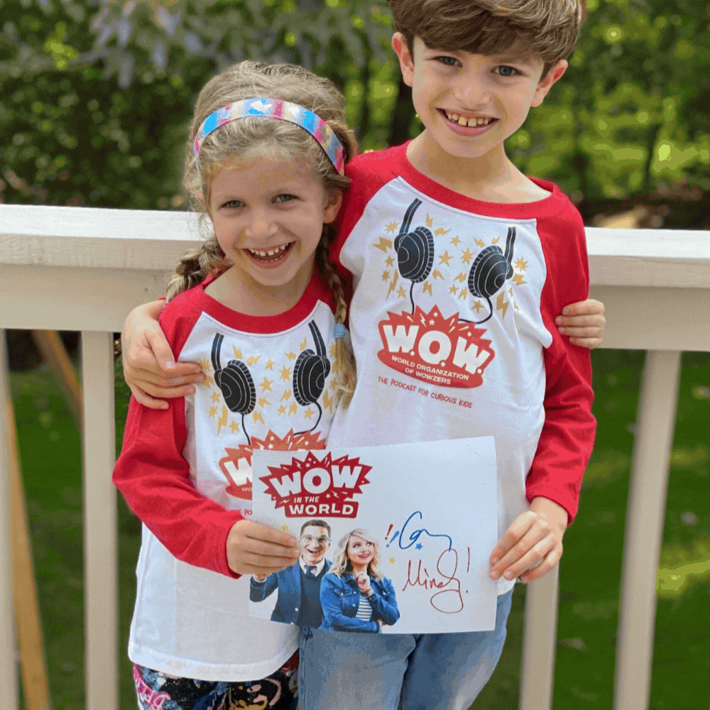 May contain two people wearing matching shirts and holding a signed picture.